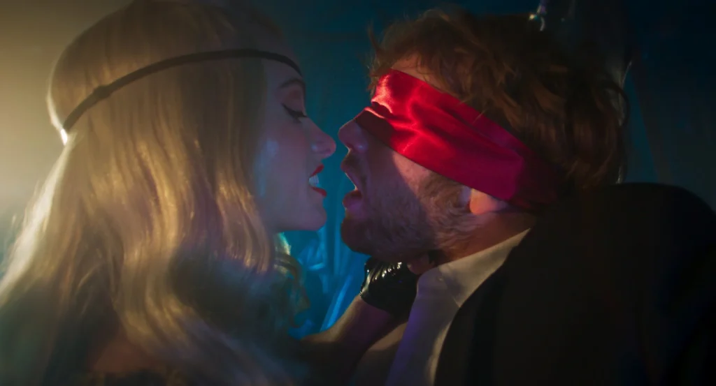Woman gripping blindfolded man's throat