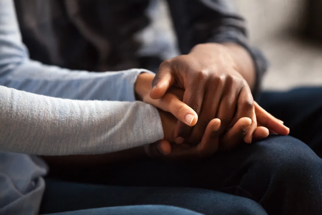 Two people clasping hands