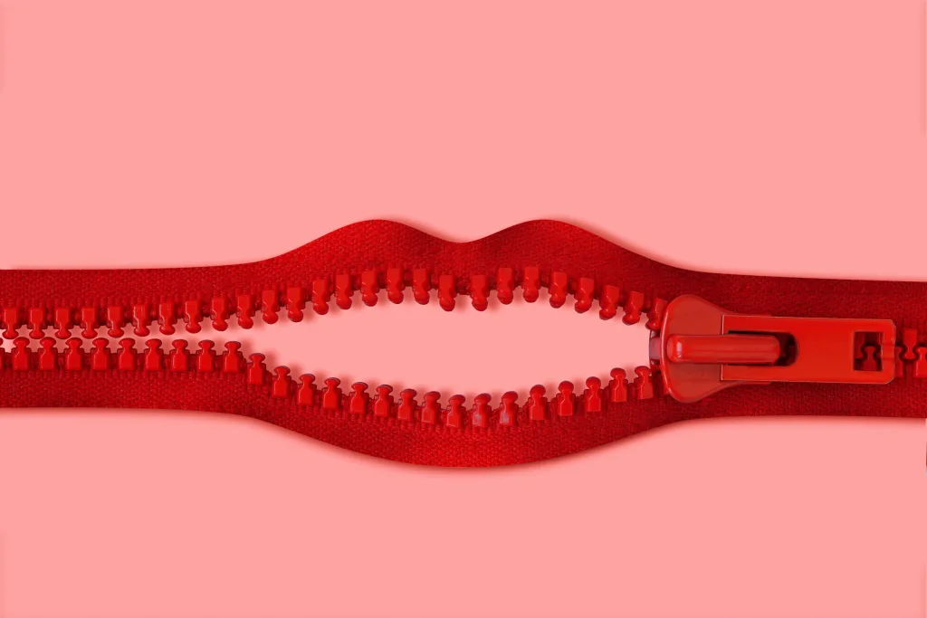 An open red zipper in the shape of lips talking