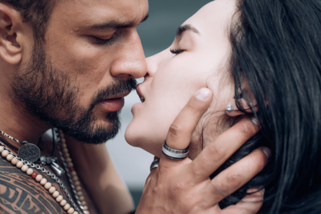 man holding woman's neck while getting ready to kiss