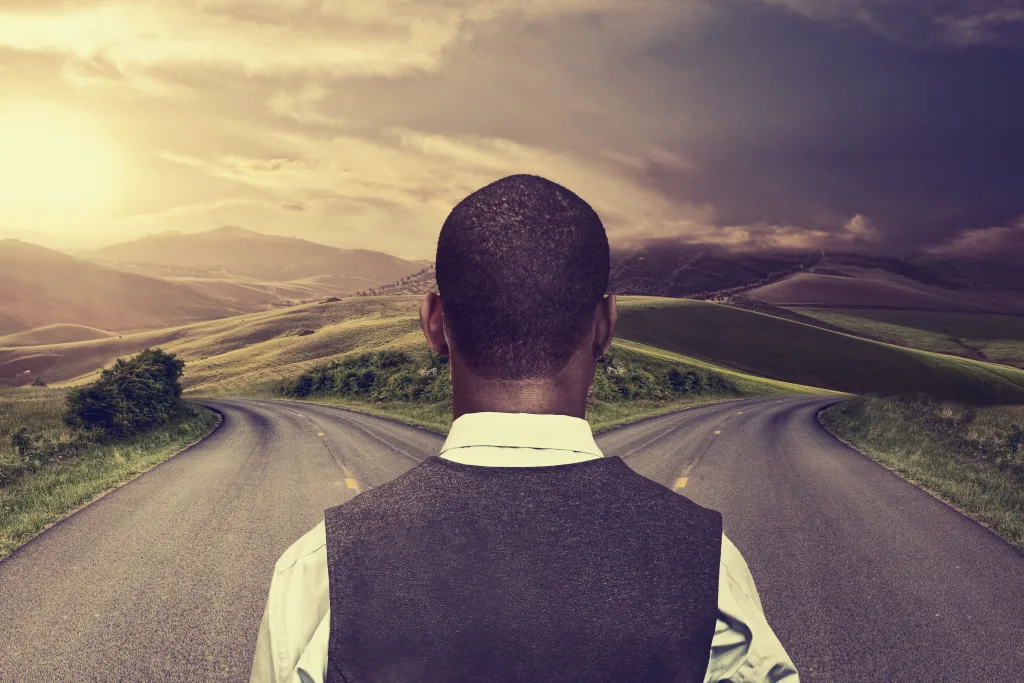 Man standing at a fork in a road