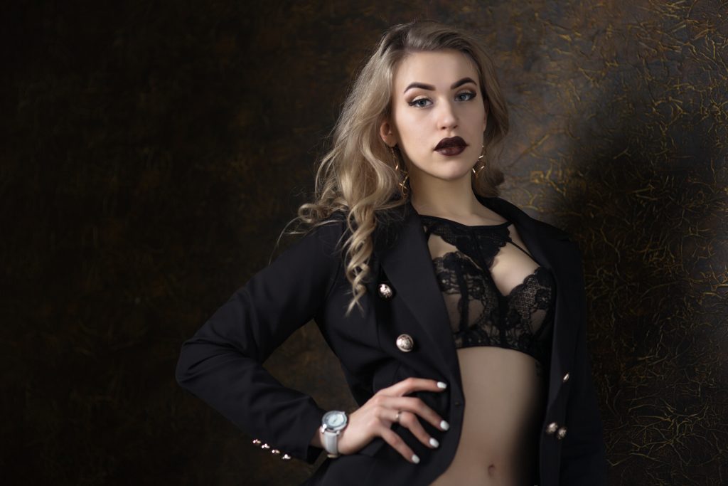 Woman wearing lingerie under a cropped jacket