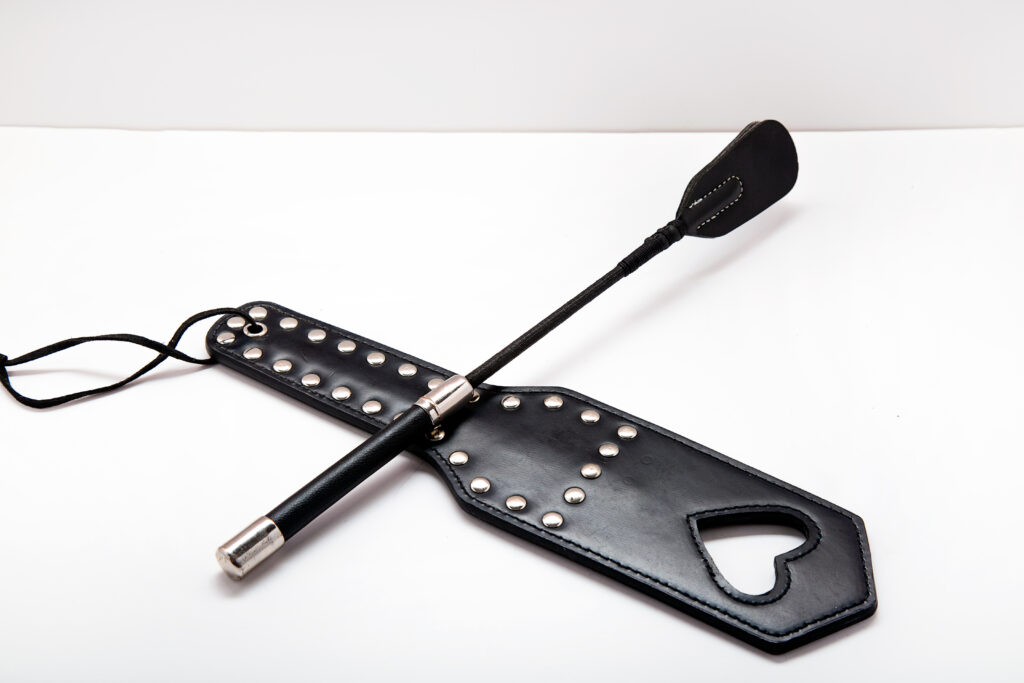Photo of a riding crop and a paddle