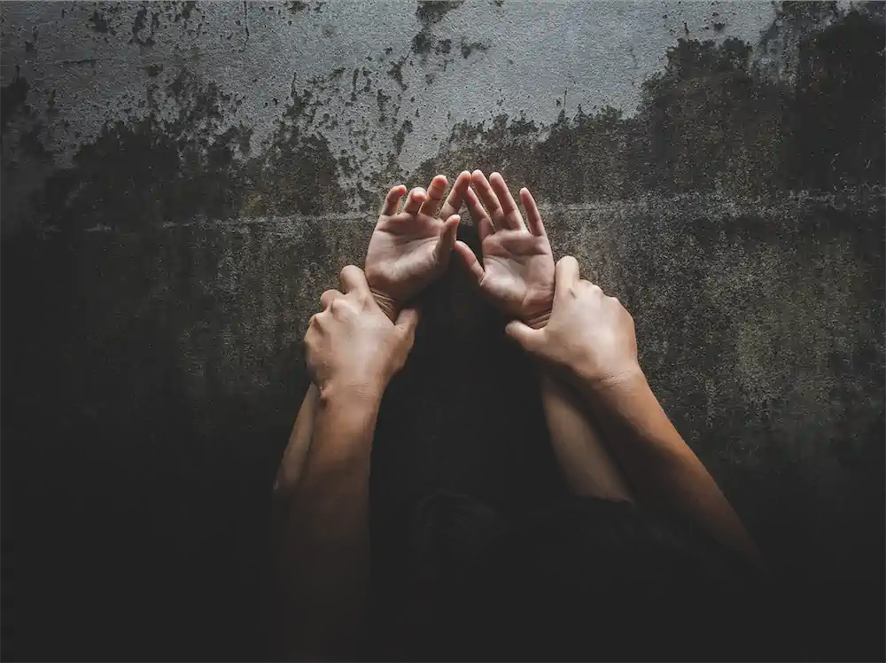 Man pinning woman's wrists to wall