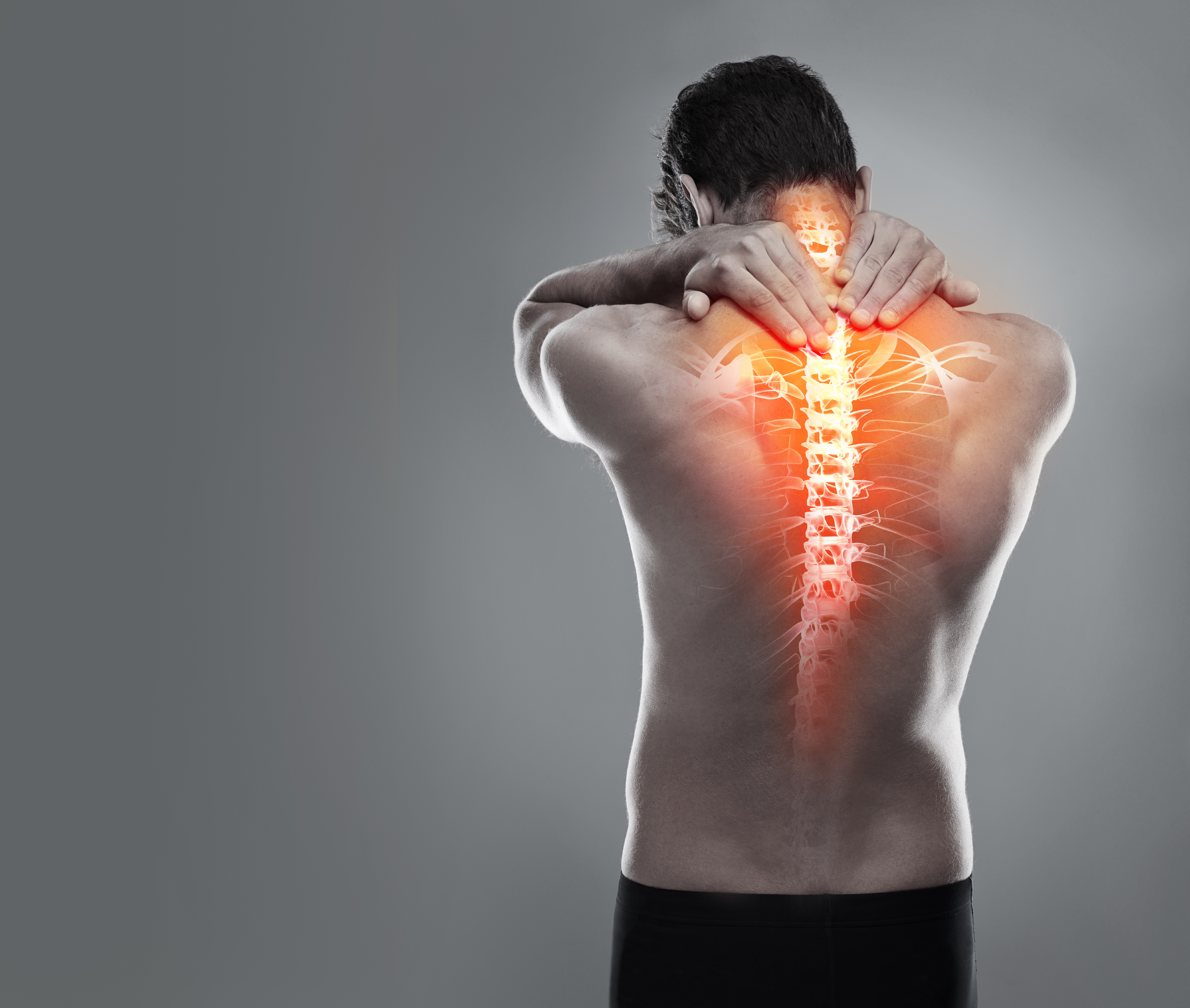 A man's back with his spine lit up in orange to show that pain is radiating from that area.